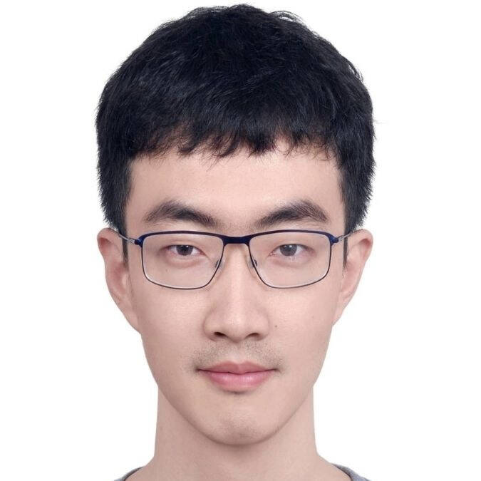 Dr. Tiehang Duan is looking straight into the Camera.